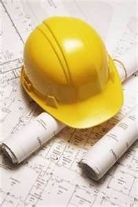 Yellow hard hat on blueprints